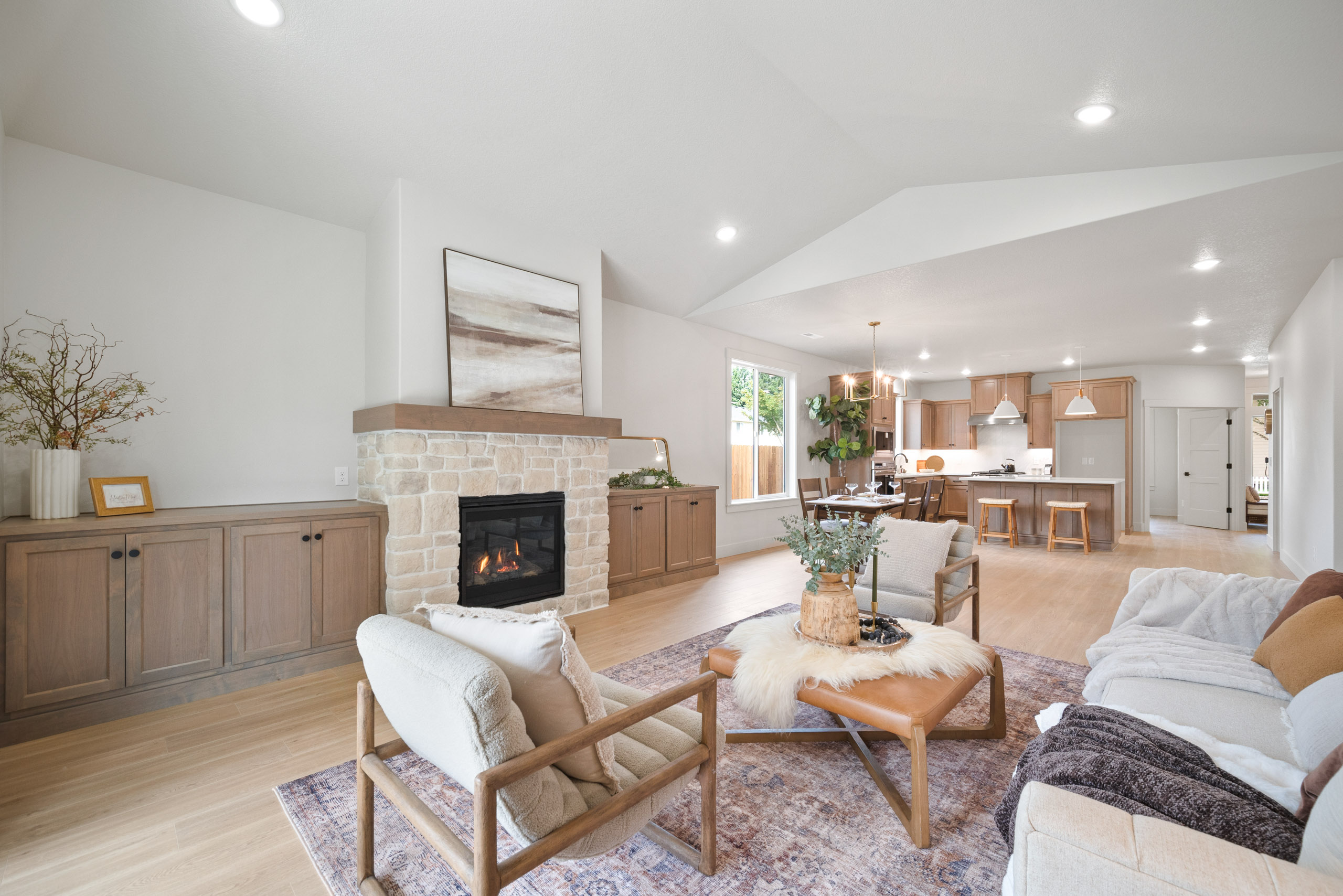 Bright living room with fireplace and open kitchen.