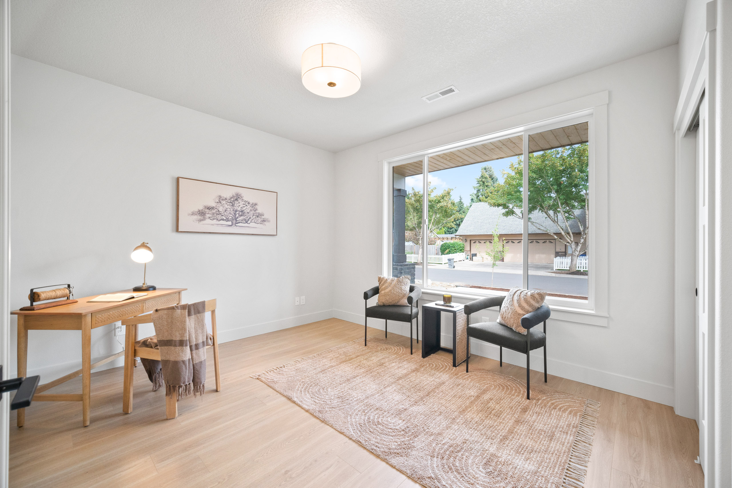 Bright living room with modern furniture and large windows.