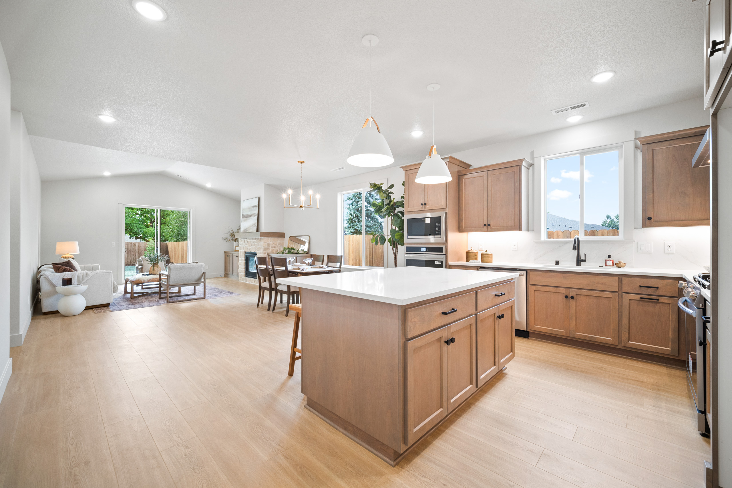 Bright kitchen with wooden cabinets, island, and modern appliances.