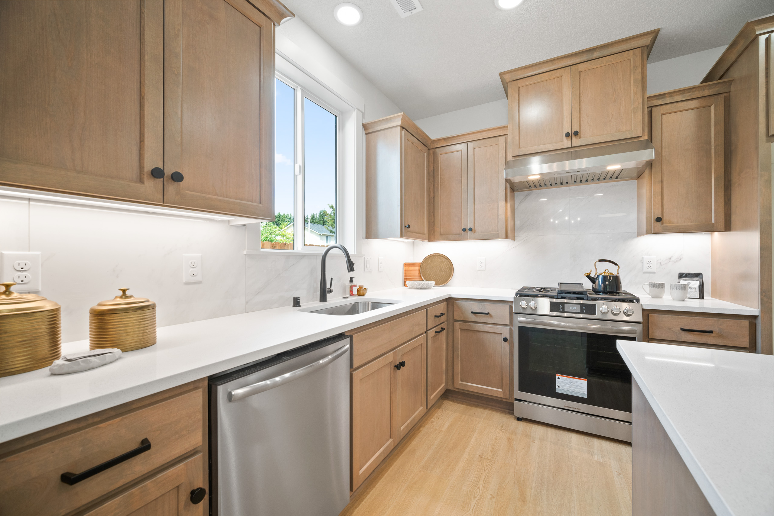 Modern kitchen with wooden cabinets and stainless steel appliances.