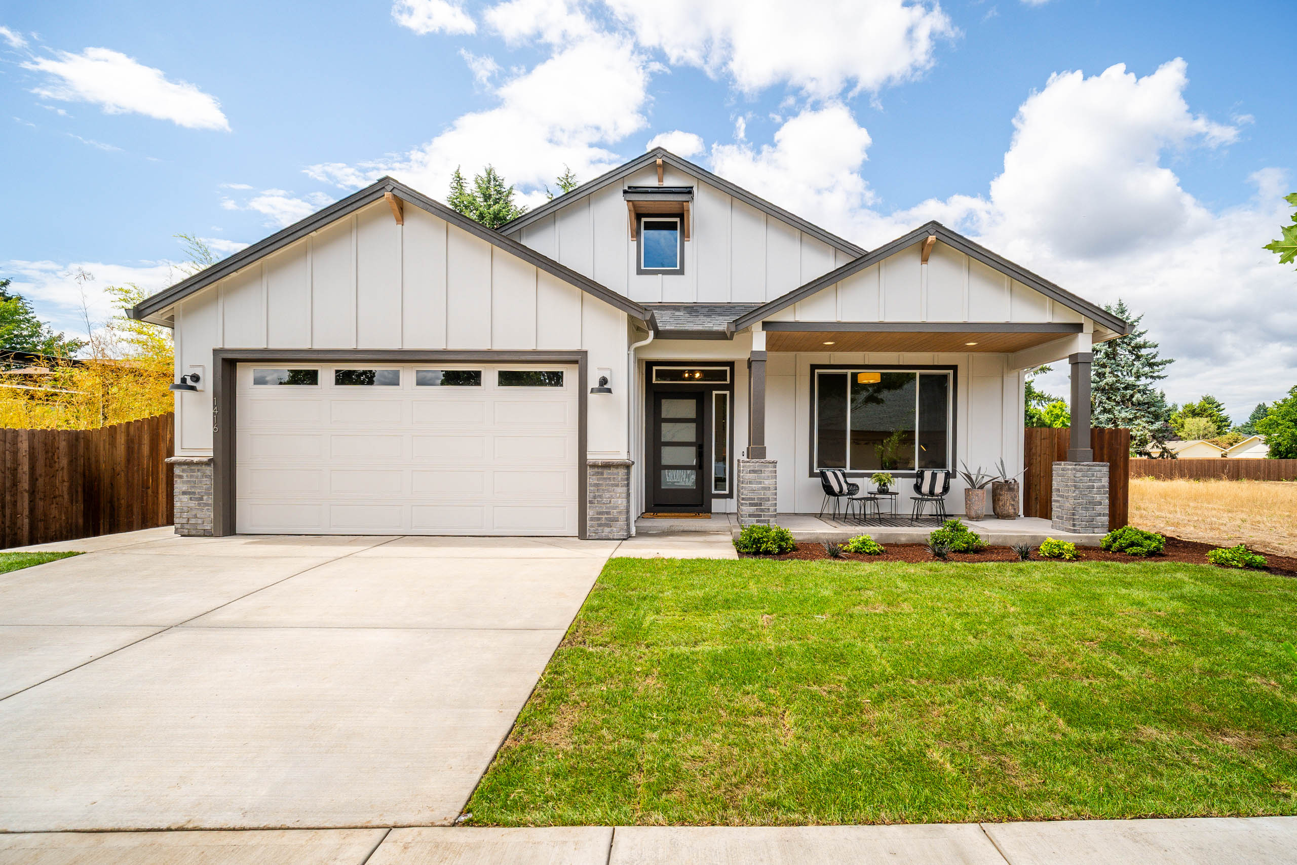 A modern single-story house with a two-car garage and a well-kept lawn.