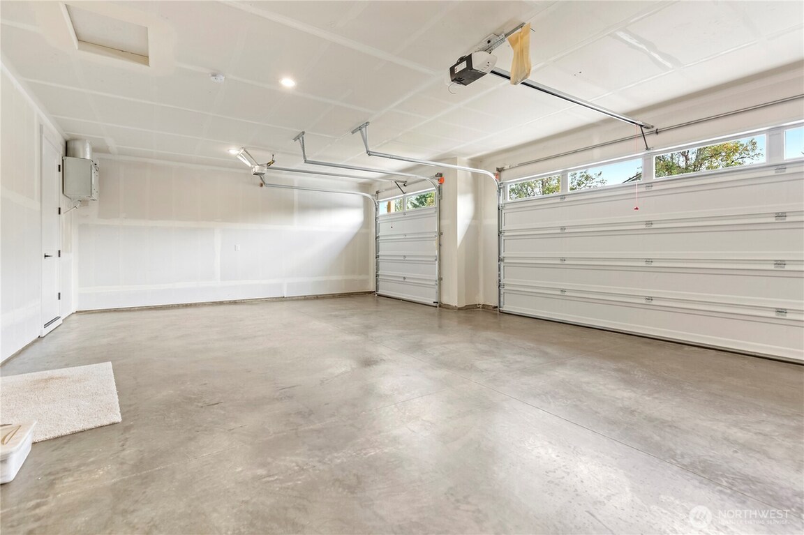 Spacious, clean garage with white walls and polished concrete floor.