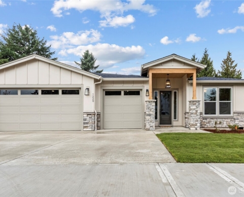 Modern single-story house with a two-car garage and front lawn.