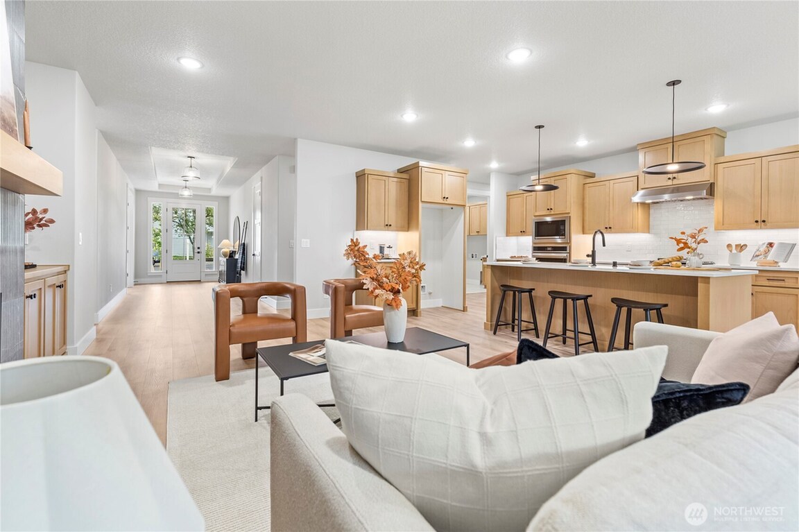 Bright open-concept living and kitchen area with modern decor.