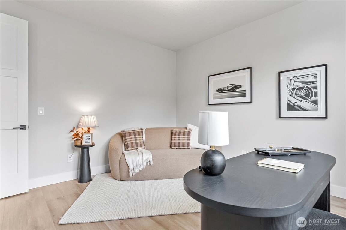Minimalist living room with neutral tones and cozy seating.