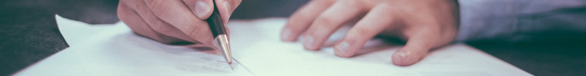 A hand gently touching a white surface.