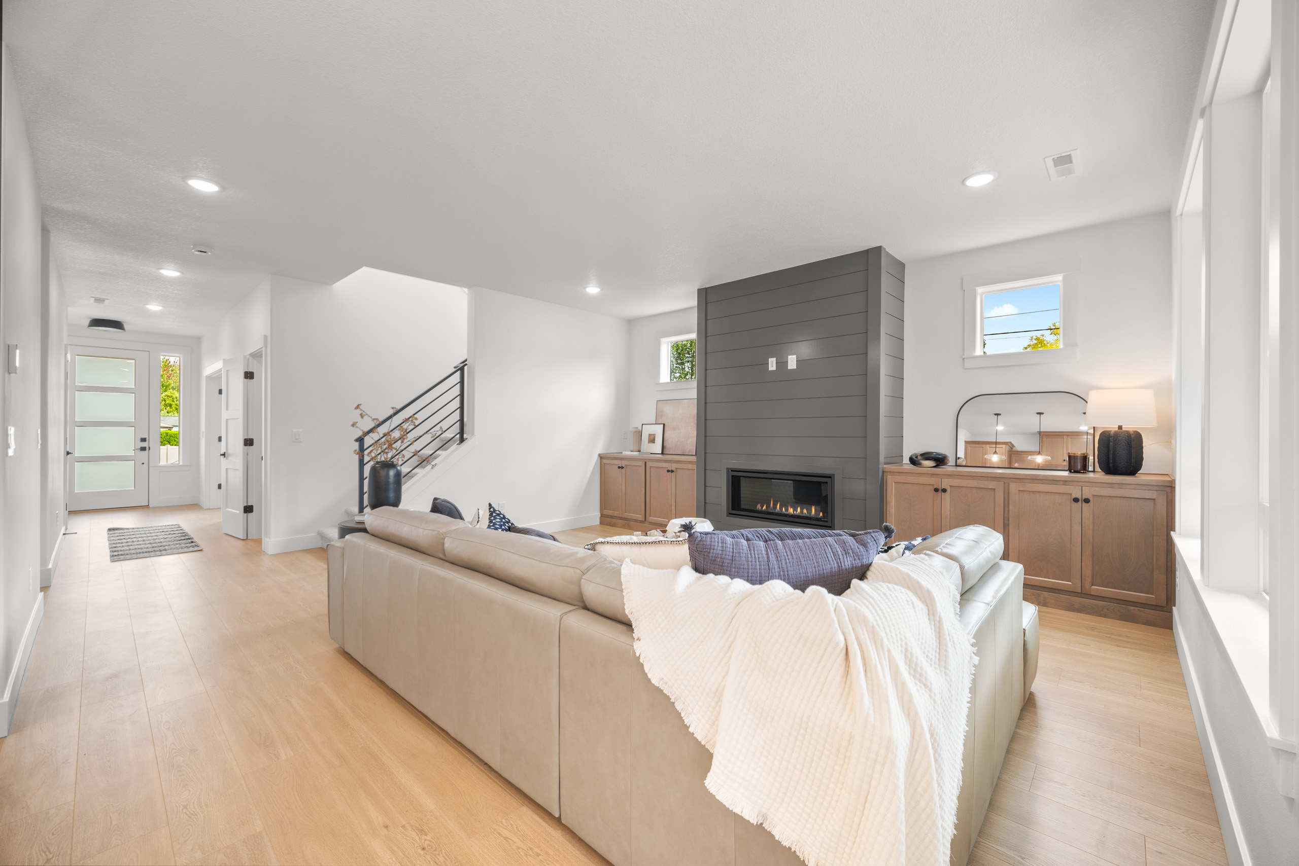 Modern living room with cozy beige sofa and minimalist decor.