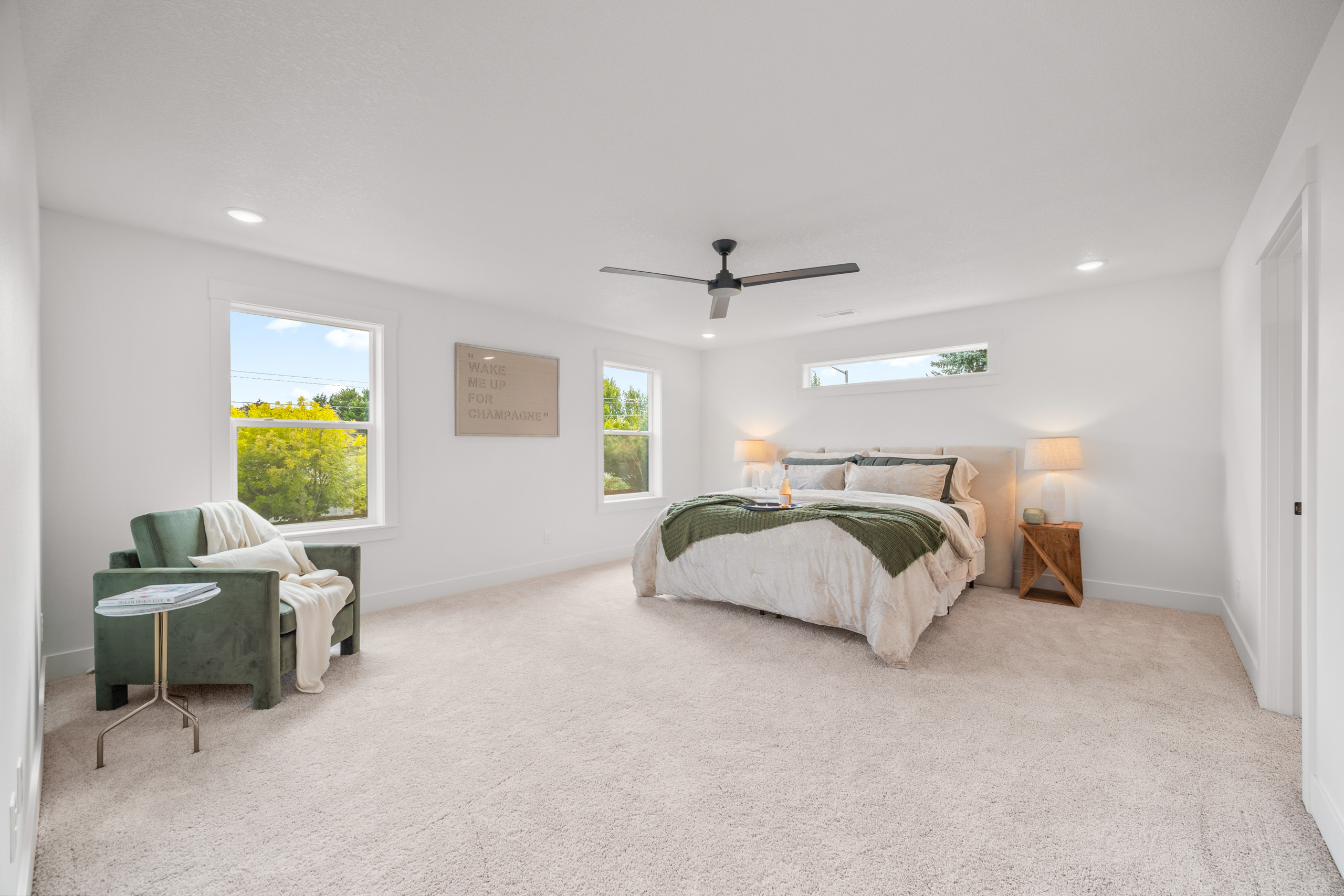 Bright and cozy bedroom with large windows and modern decor.