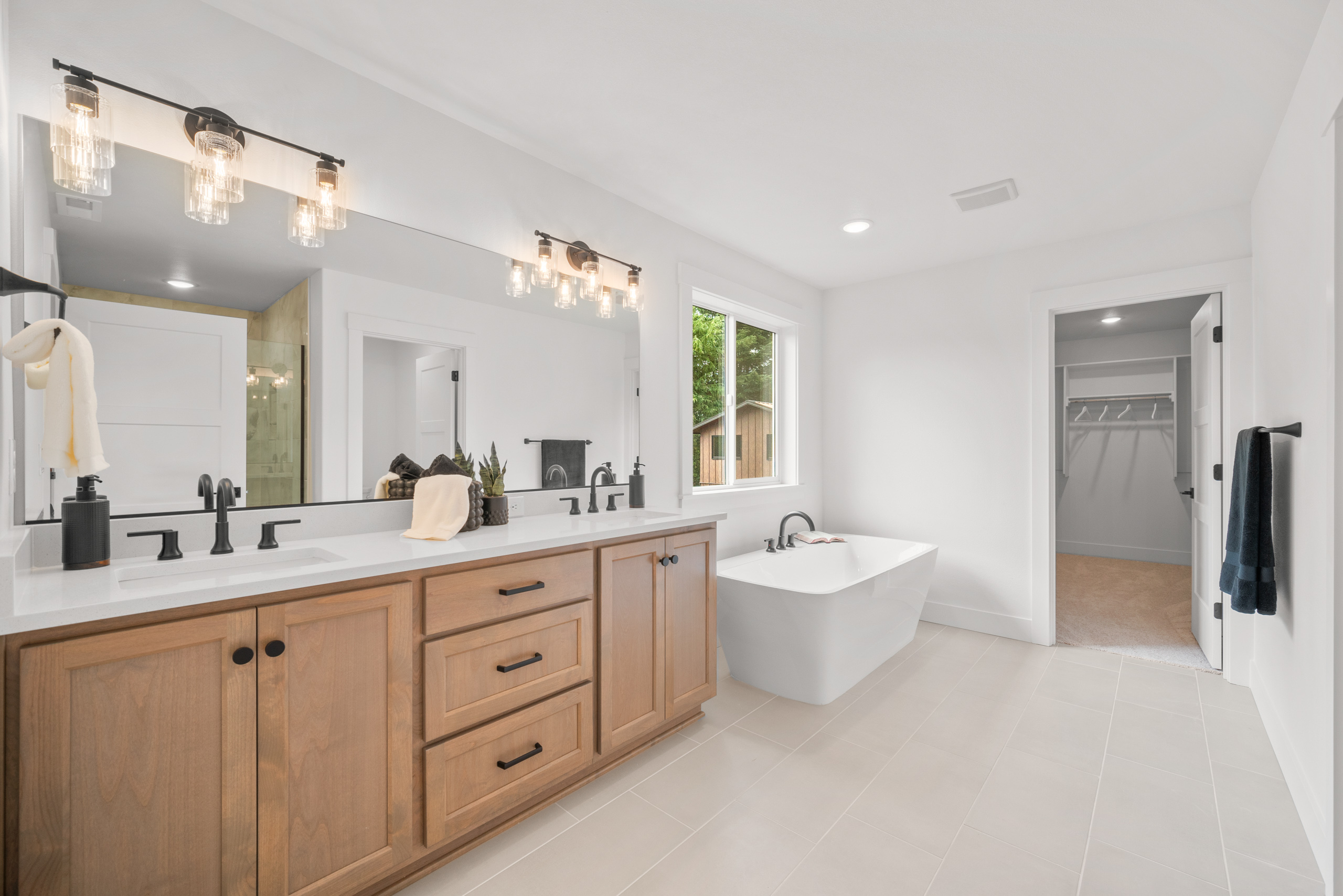 Spacious modern bathroom with double vanity and large mirror.