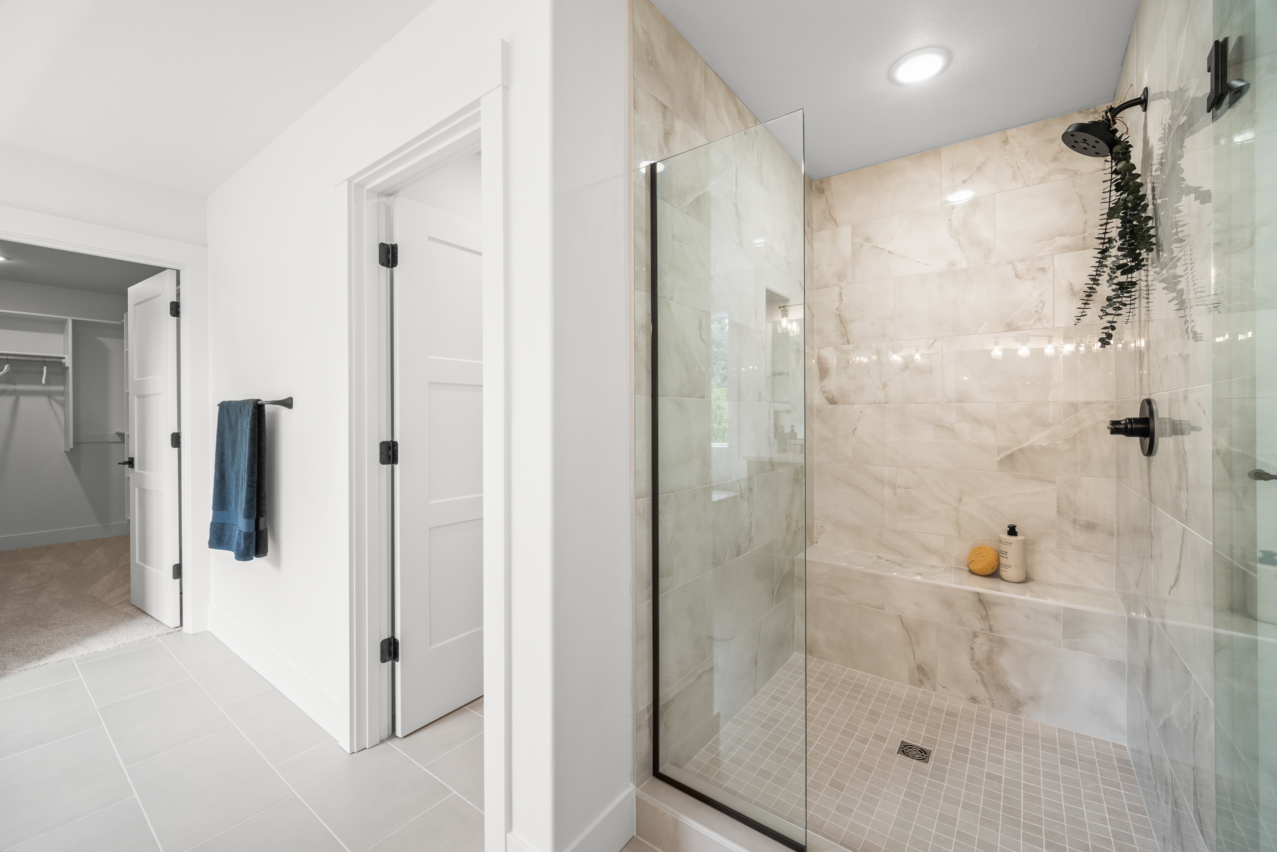 Modern bathroom with glass shower and double vanity.
