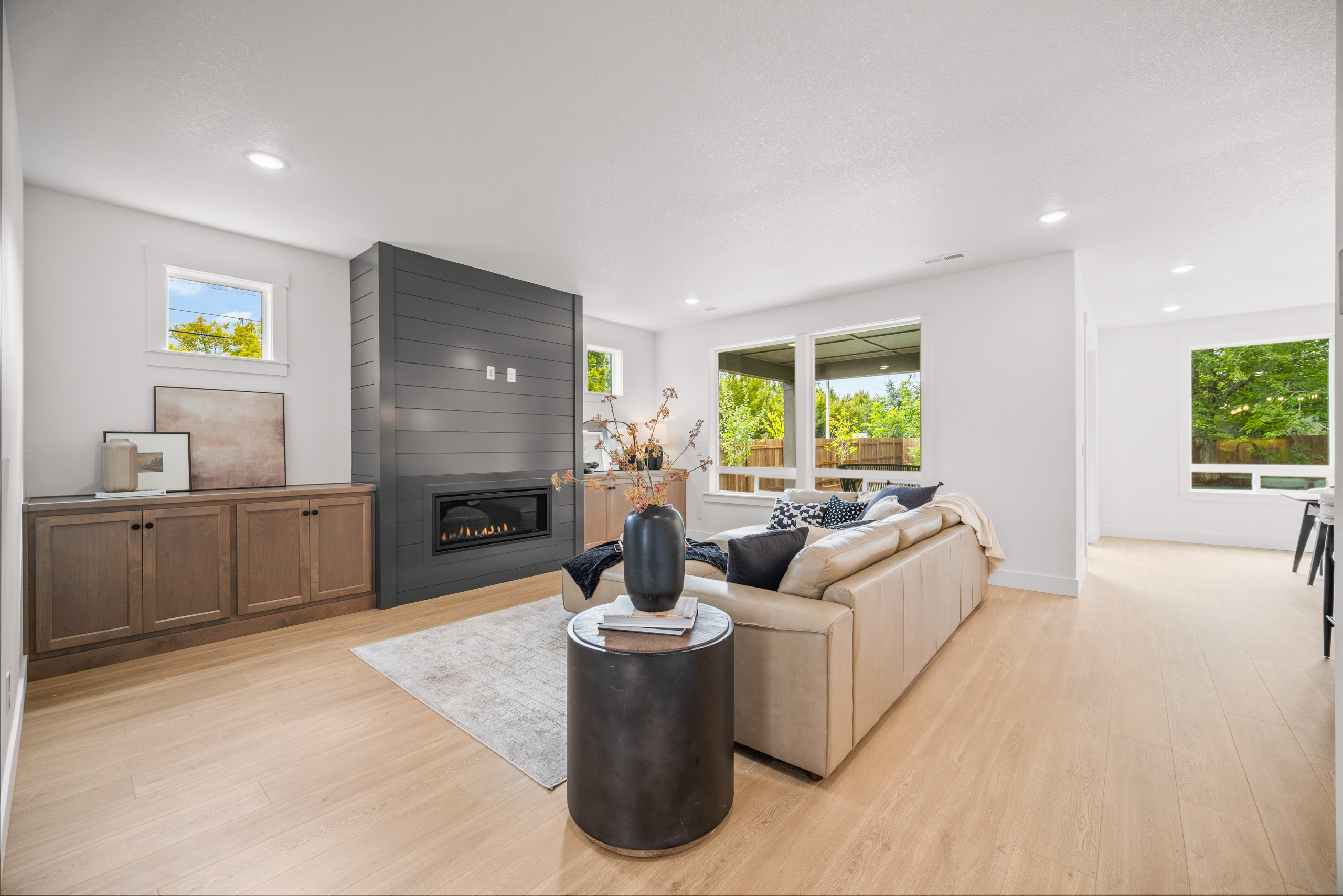 Modern living room with beige sofa and large TV.