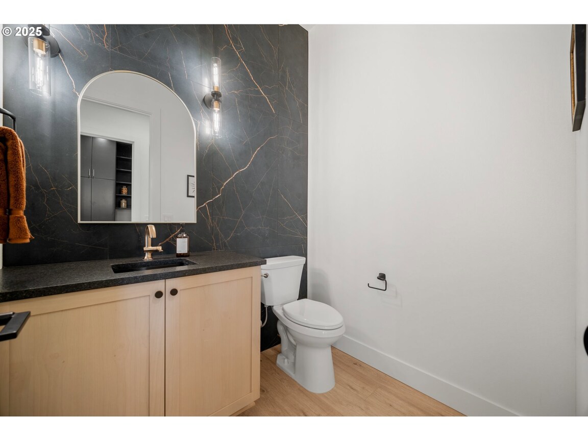 Modern bathroom with wood cabinetry and a walk-in shower.