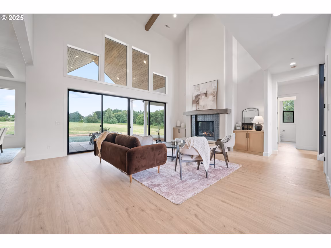 Bright living room with large windows and modern furniture.