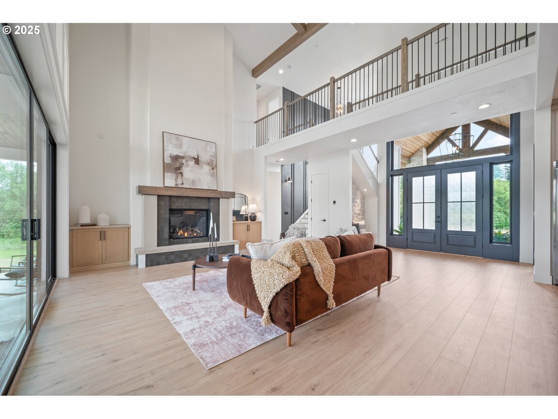 Spacious modern living room with high ceilings and large windows.
