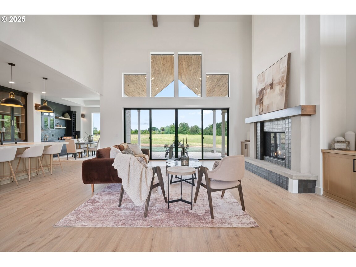 Modern living room with large windows and stylish furniture.