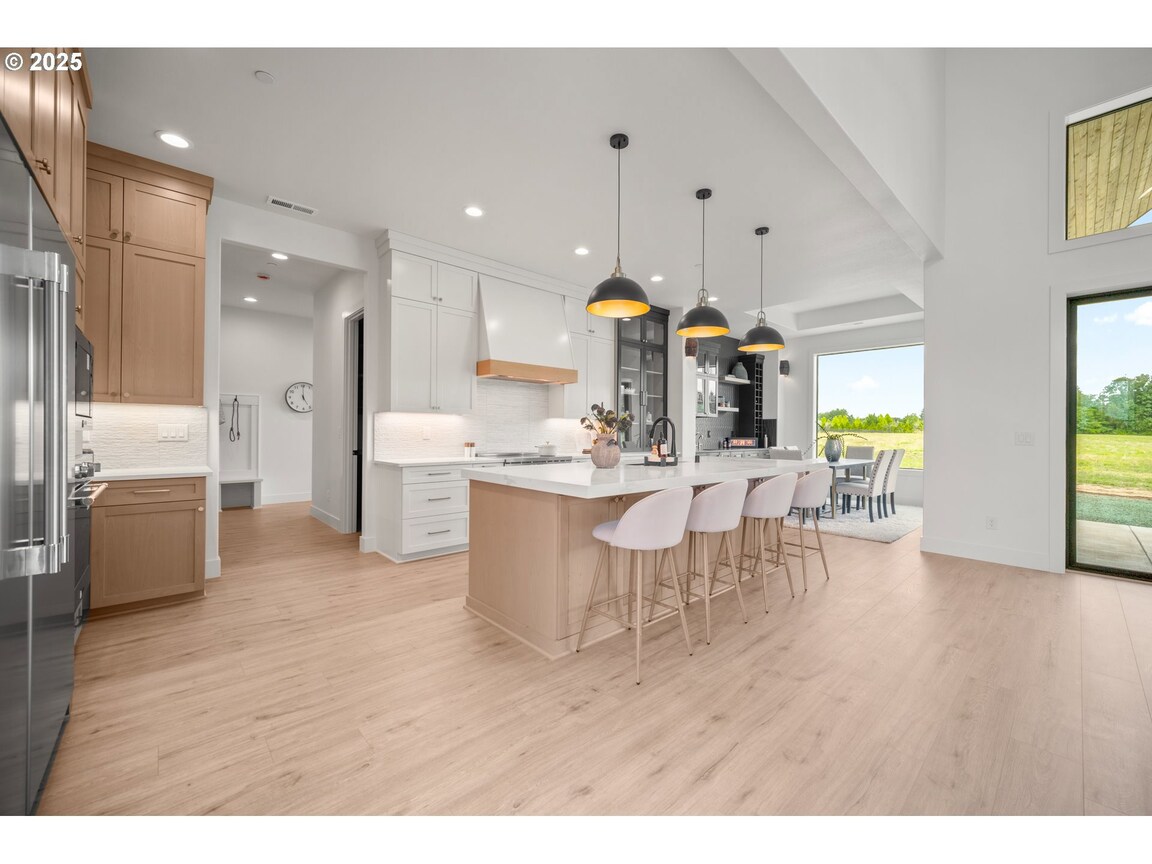 Modern kitchen with white cabinetry and a large island.