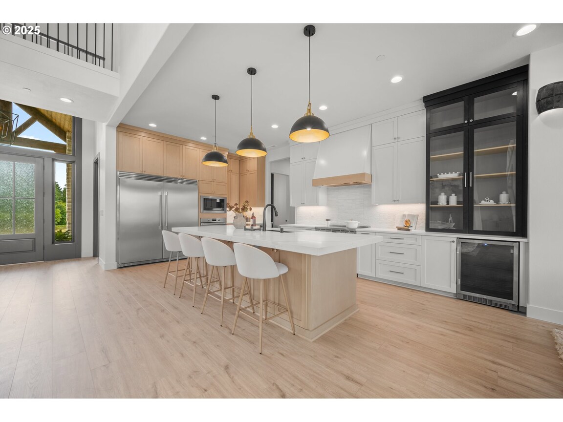 Modern kitchen with a large island and pendant lights.